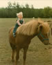 18 month old Mandy on Reddi, a young stallion.